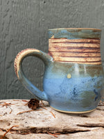 Raw clay trees and matte blue mug