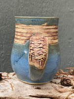 Raw clay trees and matte blue mug