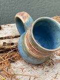 Raw clay trees and matte blue mug